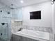 Modern bathroom featuring a glass shower, standalone tub, and dark wooden blinds at 8719 Sunlit Cove Ne Dr, St Petersburg, FL 33702