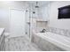 Beautiful bathroom with glass enclosed shower and a soaking tub with tile surround at 8719 Sunlit Cove Ne Dr, St Petersburg, FL 33702