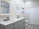 Bathroom featuring double sinks, stylish vanities, and modern fixtures at 8719 Sunlit Cove Ne Dr, St Petersburg, FL 33702