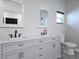 Bathroom featuring double sinks, stylish vanities, and modern fixtures at 8719 Sunlit Cove Ne Dr, St Petersburg, FL 33702