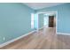 Bright bedroom with blue walls, wood floors, and a sliding closet door at 8719 Sunlit Cove Ne Dr, St Petersburg, FL 33702