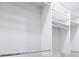 Organized closet featuring built in storage with shelving and hanging rods for clothing at 8719 Sunlit Cove Ne Dr, St Petersburg, FL 33702