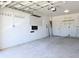 Spacious and unfinished garage with concrete floor, white walls, and a door at 8719 Sunlit Cove Ne Dr, St Petersburg, FL 33702