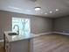 Kitchen island with an open concept space and view to backyard at 8719 Sunlit Cove Ne Dr, St Petersburg, FL 33702