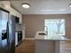 Modern kitchen with white cabinets, stainless steel appliances, and a view of the outdoors from the kitchen island at 8719 Sunlit Cove Ne Dr, St Petersburg, FL 33702