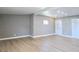 Spacious living room features modern floors, neutral paint, and a decorative stained glass window at 8719 Sunlit Cove Ne Dr, St Petersburg, FL 33702