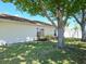 Lush lawn and manicured landscaping accentuating the home's exterior at 8719 Sunlit Cove Ne Dr, St Petersburg, FL 33702