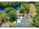 Stunning aerial view of estate home featuring a backyard pool and private dock at 898 Cypress Lakeview Ct, Tarpon Springs, FL 34688