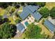 Luxury home featuring a backyard pool, lush landscaping and detached garage at 898 Cypress Lakeview Ct, Tarpon Springs, FL 34688
