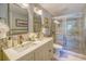 Bathroom with double sinks and a glass-enclosed shower at 898 Cypress Lakeview Ct, Tarpon Springs, FL 34688