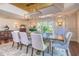 Elegant dining room with custom wall paneling and many windows that bring in ample natural light at 898 Cypress Lakeview Ct, Tarpon Springs, FL 34688