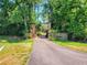 Beautiful tree-lined driveway with stone gate entrance at 898 Cypress Lakeview Ct, Tarpon Springs, FL 34688