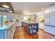 Spacious kitchen with a center island, granite countertops, white cabinetry and stainless steel appliances at 898 Cypress Lakeview Ct, Tarpon Springs, FL 34688