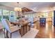 Open-concept kitchen and dining area boasts a wooden dining table, hardwood floors, and a fireplace at 898 Cypress Lakeview Ct, Tarpon Springs, FL 34688