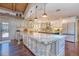 Bright kitchen with white cabinetry, granite countertops, stainless steel appliances and an island at 898 Cypress Lakeview Ct, Tarpon Springs, FL 34688