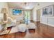 Bright living room with hardwood floors, stylish decor, and French doors to the backyard at 898 Cypress Lakeview Ct, Tarpon Springs, FL 34688
