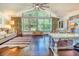 Bright living room with vaulted ceilings, large windows, and hardwood floors at 898 Cypress Lakeview Ct, Tarpon Springs, FL 34688