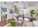 Open-concept living space with hardwood floors, wainscoting, and views into the bedroom at 898 Cypress Lakeview Ct, Tarpon Springs, FL 34688