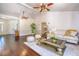 Spacious living room featuring hardwood floors, white wainscoting, and comfortable seating at 898 Cypress Lakeview Ct, Tarpon Springs, FL 34688