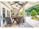 The outdoor patio offers a relaxed seating area with comfortable chairs and a ceiling fan at 898 Cypress Lakeview Ct, Tarpon Springs, FL 34688