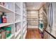 Walk-in pantry with custom shelving, a refrigerator, and plenty of space for storage at 898 Cypress Lakeview Ct, Tarpon Springs, FL 34688