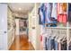 Large walk-in closet with custom shelving, and hardwood floors for ample storage at 898 Cypress Lakeview Ct, Tarpon Springs, FL 34688
