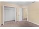 Bedroom featuring a carpeted floor, neutral walls, a closet, and an ensuite bathroom at 9908 Spice Bush Ct, Tampa, FL 33647