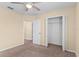 Bedroom featuring a carpeted floor, neutral walls, a closet, and an ensuite bathroom at 9908 Spice Bush Ct, Tampa, FL 33647