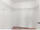 Open white walk-in closet with metal racks at 9908 Spice Bush Ct, Tampa, FL 33647