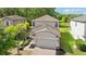 Charming two-story home with a well-manicured lawn and brick-paved driveway at 9908 Spice Bush Ct, Tampa, FL 33647