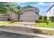 Charming two-story home with a well-manicured lawn and brick-paved driveway at 9908 Spice Bush Ct, Tampa, FL 33647