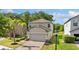 Charming two-story home with a well-manicured lawn and brick-paved driveway at 9908 Spice Bush Ct, Tampa, FL 33647