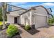 Inviting front entrance with a brick-paved walkway and manicured landscaping at 9908 Spice Bush Ct, Tampa, FL 33647