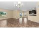 Spacious living room with tile floors and access to kitchen and outdoor patio at 9908 Spice Bush Ct, Tampa, FL 33647