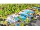 Community pool area showcasing a bridge, slide, and plenty of lounge chairs for residents' enjoyment at 9908 Spice Bush Ct, Tampa, FL 33647