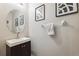 Contemporary powder room with a round mirror and stylish fixtures, enhancing its appeal at 10687 Lake Montauk Dr, Riverview, FL 33578