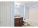 Bright bathroom featuring a shower-tub combo and a granite-look vanity with a white sink at 10687 Lake Montauk Dr, Riverview, FL 33578
