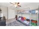This cozy bedroom features a bunk bed, soft carpet, and a ceiling fan for added comfort at 10687 Lake Montauk Dr, Riverview, FL 33578