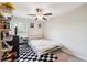 A well-lit bedroom with a ceiling fan and a checkered rug, offering a cozy and inviting space at 10687 Lake Montauk Dr, Riverview, FL 33578