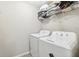 Functional laundry room featuring a side-by-side washer and dryer and ample storage space above at 10687 Lake Montauk Dr, Riverview, FL 33578