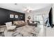 Bright living room with stylish furnishings and a modern accent wall, creating a welcoming atmosphere at 10687 Lake Montauk Dr, Riverview, FL 33578