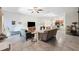 Open-concept living space with a ceiling fan, connecting the living room, dining area, and kitchen at 10687 Lake Montauk Dr, Riverview, FL 33578