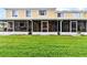 Backyard view of the yellow home with screened-in patios at 10807 Keys Gate Dr, Riverview, FL 33579