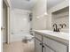 Bright bathroom features a shower-tub combo with white tile surround, plus a white vanity sink at 10807 Keys Gate Dr, Riverview, FL 33579