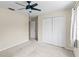 This is a bedroom with neutral walls, carpet, double door closet, and a ceiling fan at 10807 Keys Gate Dr, Riverview, FL 33579