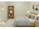Cozy bedroom design showcasing a bed with neutral bedding, bookcase, and neutral walls at 10807 Keys Gate Dr, Riverview, FL 33579
