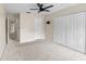 This is an empty bedroom with neutral walls, carpet, a ceiling fan, and double door closet at 10807 Keys Gate Dr, Riverview, FL 33579