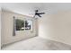 Bedroom with neutral walls, carpet, a ceiling fan, a window, and a curtain at 10807 Keys Gate Dr, Riverview, FL 33579