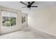 This is an empty bedroom with neutral walls, carpet, and two windows with wooded views at 10807 Keys Gate Dr, Riverview, FL 33579