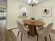 Dining room featuring hardwood floors, a modern chandelier, and a view into the kitchen at 10807 Keys Gate Dr, Riverview, FL 33579